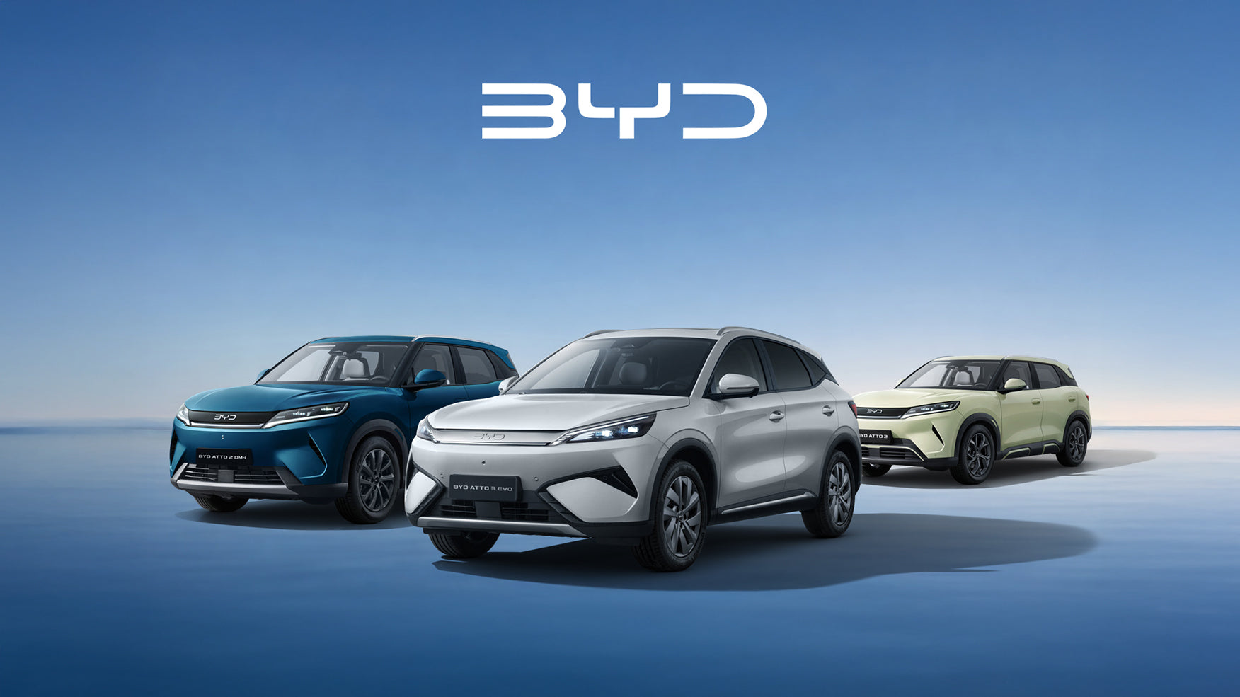 Three BYD electric SUVs are shown in a clean studio-style scene against a blue gradient background, with the BYD logo centered above them. The vehicles are arranged from left to right in blue, white, and pale yellow-green.